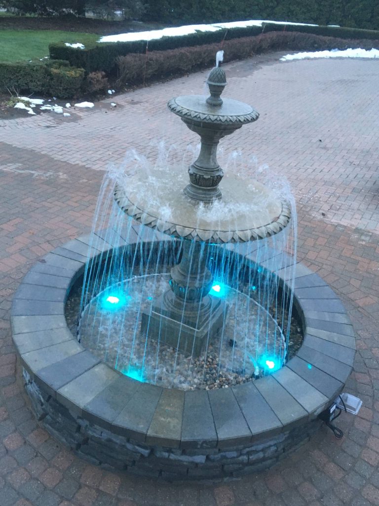 Concrete fountain with highlighted spray ring